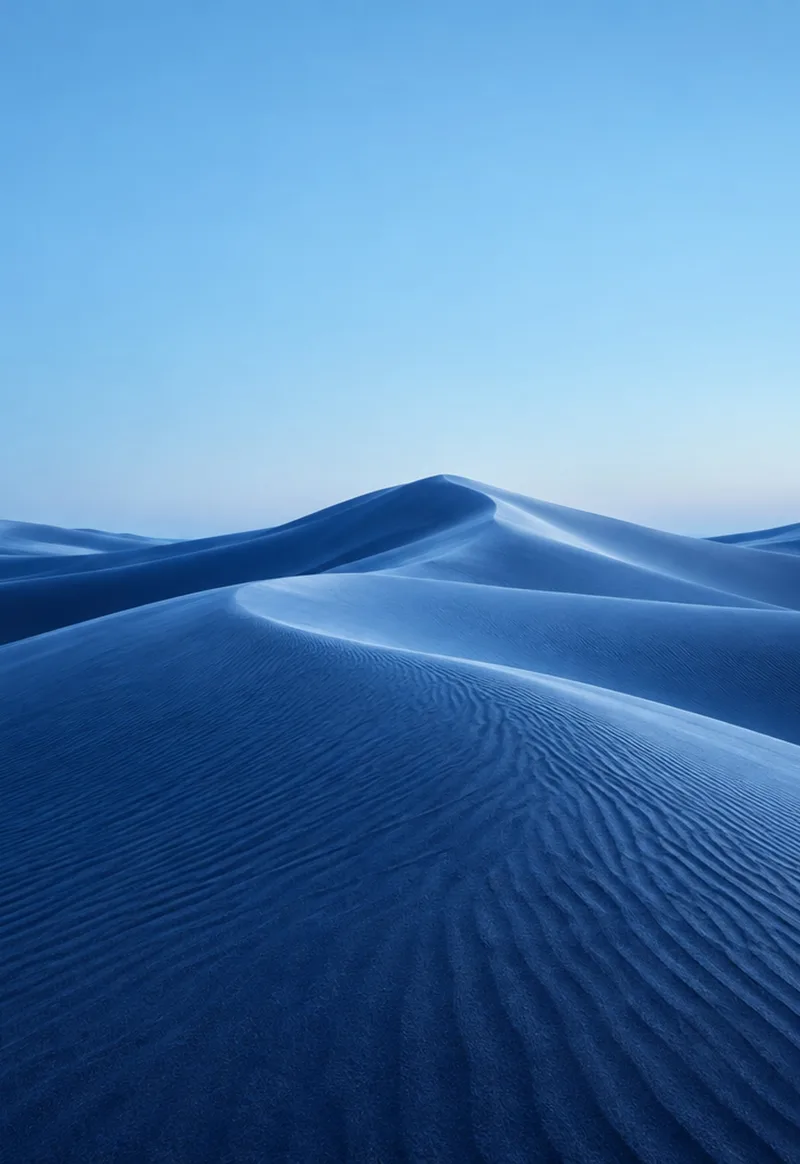 Powder-blue dune crests flow into indigo shadows beneath an open sky. — Cover Display