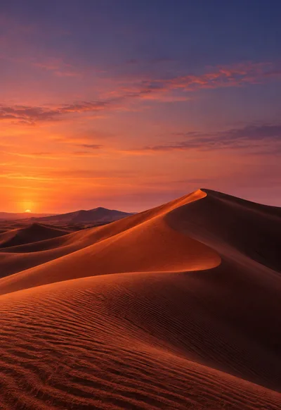 Terracotta dunes catch an amber rim beneath a rose and indigo dusk.
