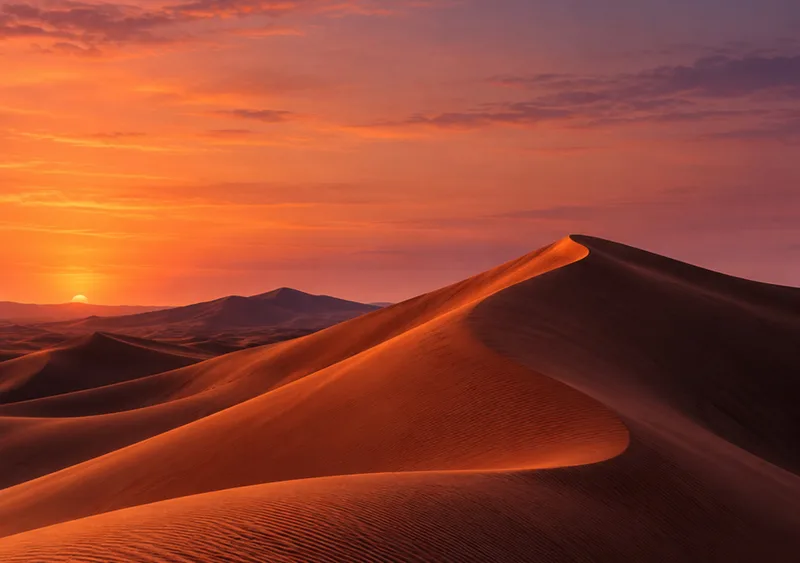 Terracotta dunes catch an amber rim beneath a rose and indigo dusk. — Inner Display