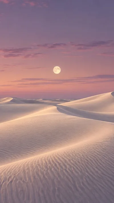 A small moon lights ivory dunes beneath a soft mauve dusk.