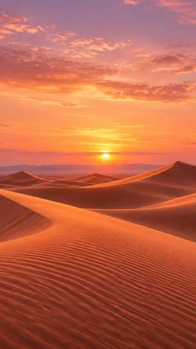 Terracotta dunes catch golden light beneath a peach and lavender sky.