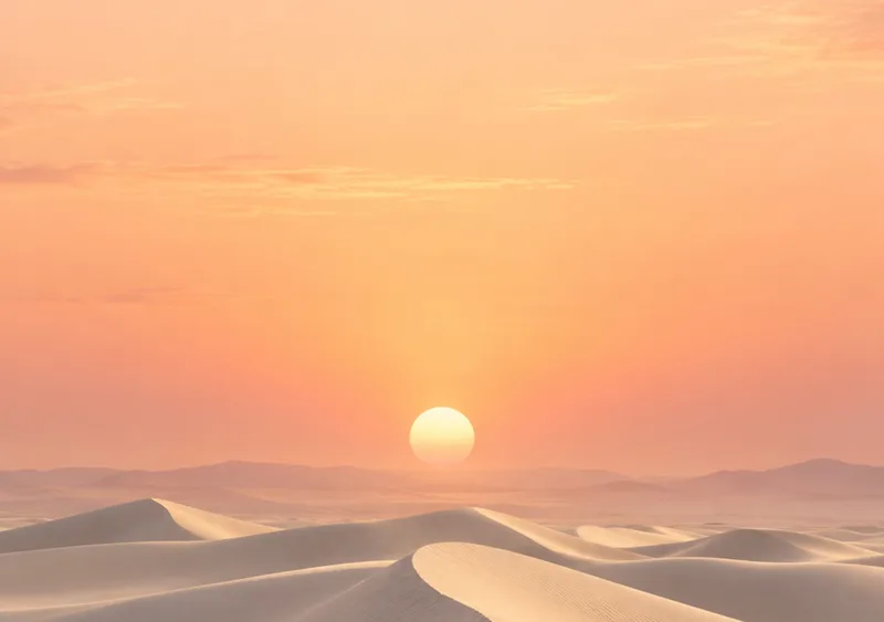 Ivory dunes rest beneath an open apricot sky. — Inner Display